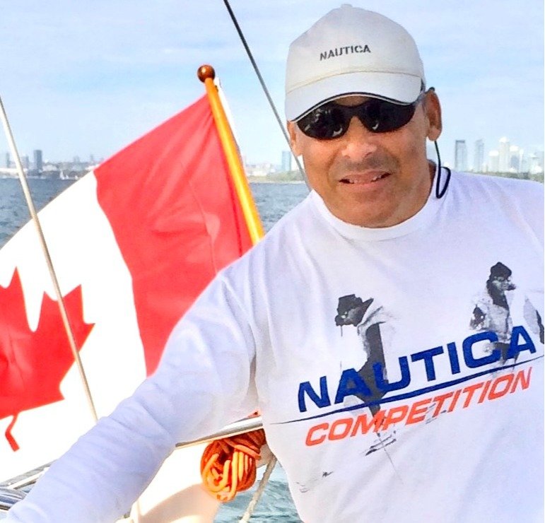 Man sailing with Canadian flag on boat