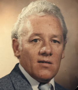 Portrait of an older man in a suit.