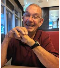 Smiling man sitting in a restaurant.