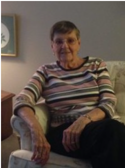 Elderly woman sitting in a cozy living room