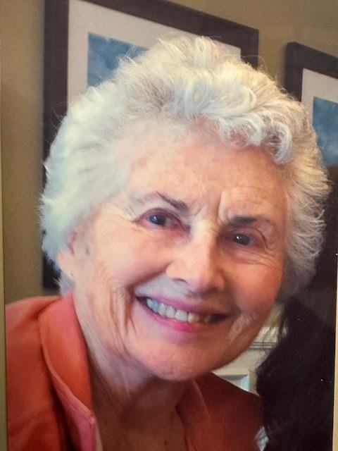 Smiling elderly woman with white hair.