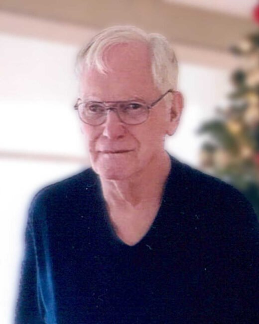 Elderly man smiling indoors.