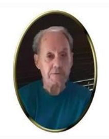 Elderly man in blue shirt, oval frame portrait.