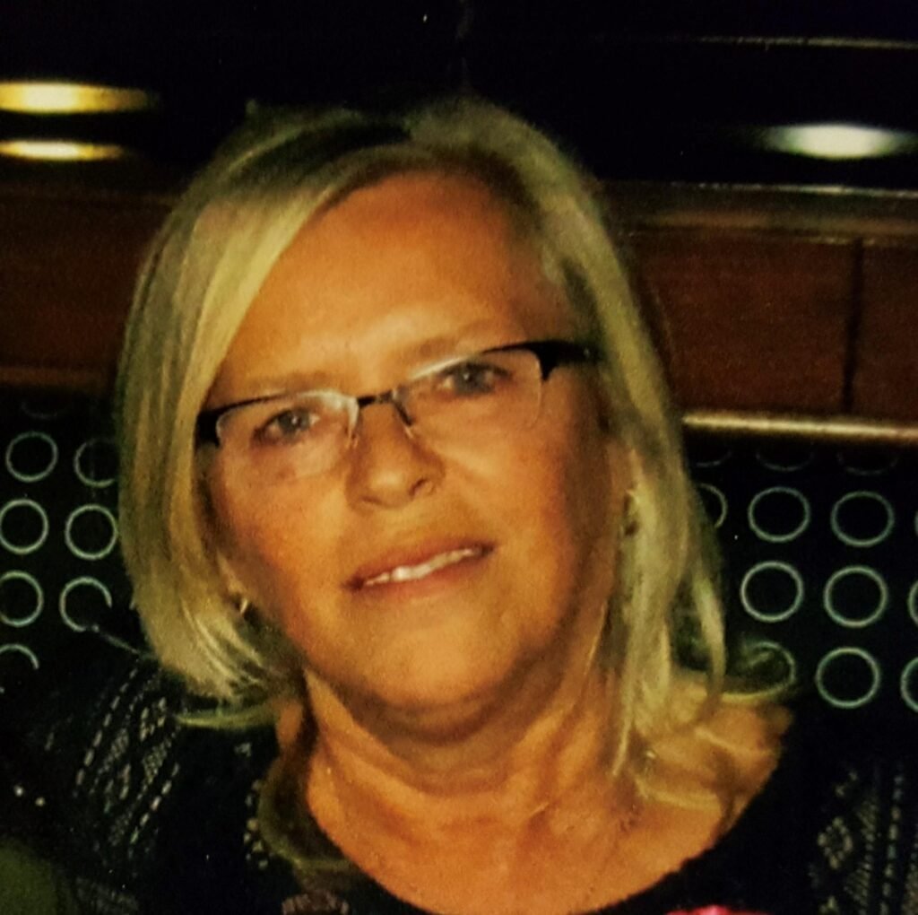 Smiling woman with glasses and blonde hair
