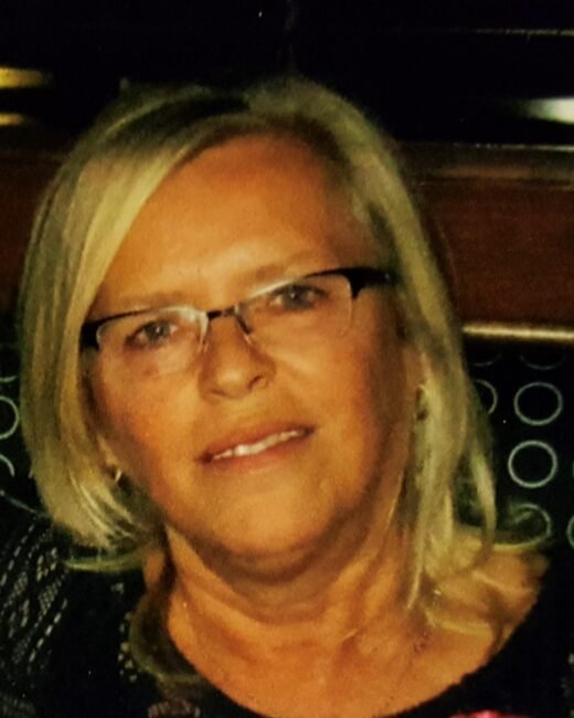 Smiling woman with glasses and blonde hair