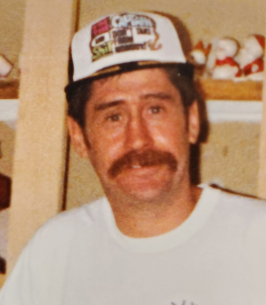 Man with mustache wearing a cap indoors.