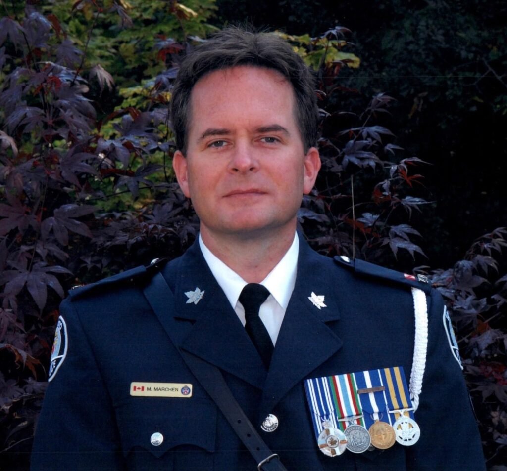 MARCHEN, Michael Marchen Uniformed officer with medals outdoors.