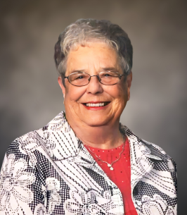 WILSON, Myra Jean Wilson Smiling woman in glasses and patterned blouse