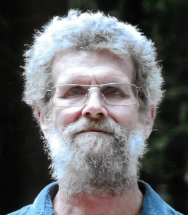 Elderly man with glasses and beard outside