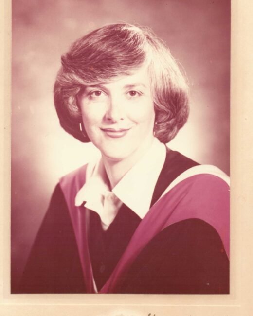 Portrait of a woman in academic robe.