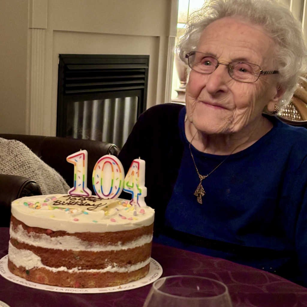 DOUEY, Marian Elizabeth Douey Elderly woman with 104th birthday cake.