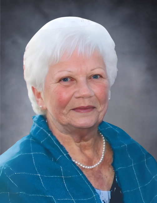 Elderly woman smiling in a blue jacket