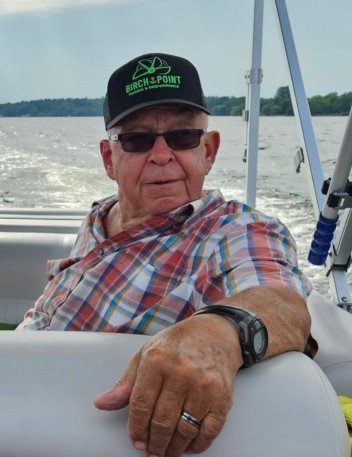 Man in plaid shirt on a boat ride