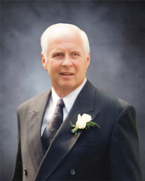 YOUMANS, Douglas "Doug" Youmans Older man in suit with white flower boutonniere.