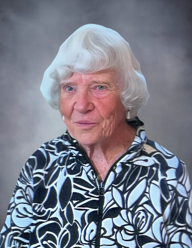 Elderly woman with white hair, floral jacket.