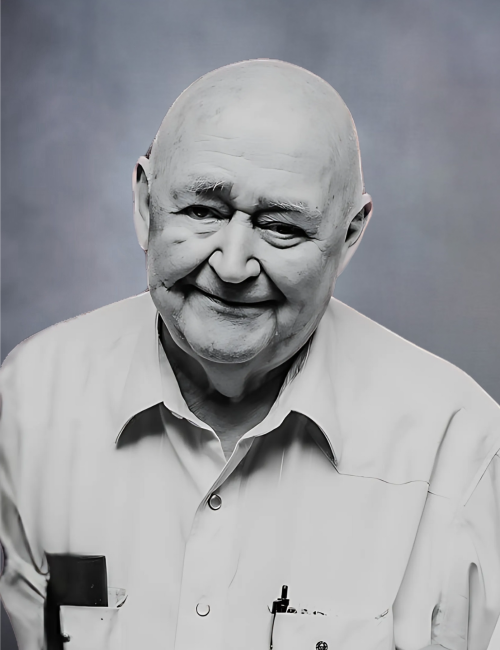 Smiling elderly man in a dress shirt.