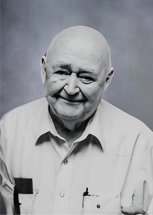 Smiling elderly man in a dress shirt.