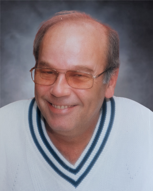 Smiling man wearing glasses and sweater