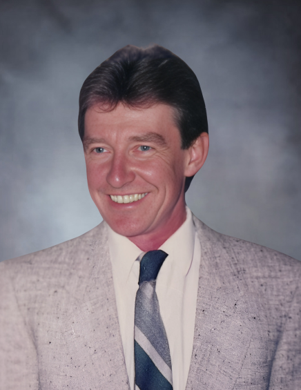 Smiling man in gray suit and tie.