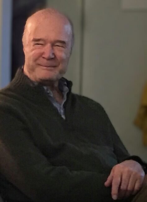 Smiling elderly man seated indoors