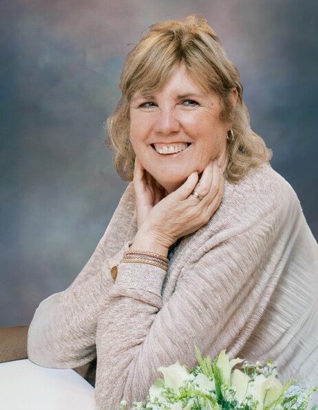 Smiling woman with flowers and soft background