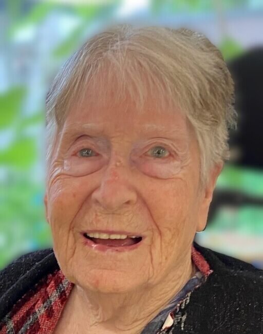 Smiling elderly woman with short gray hair.