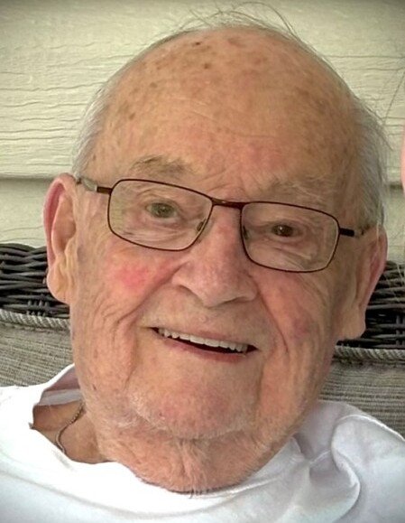 Smiling elderly man with glasses outdoors