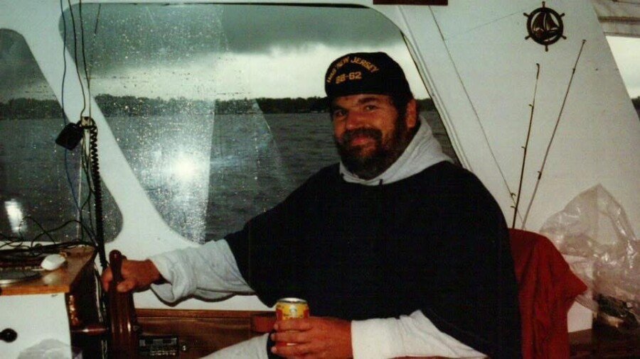 HORDIJK, Bernhard "Ben" Hordijk Man steering boat with drink in hand.