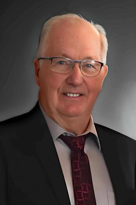 Man in suit and glasses smiling portrait