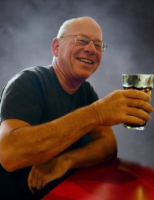 Man smiling and holding a drink