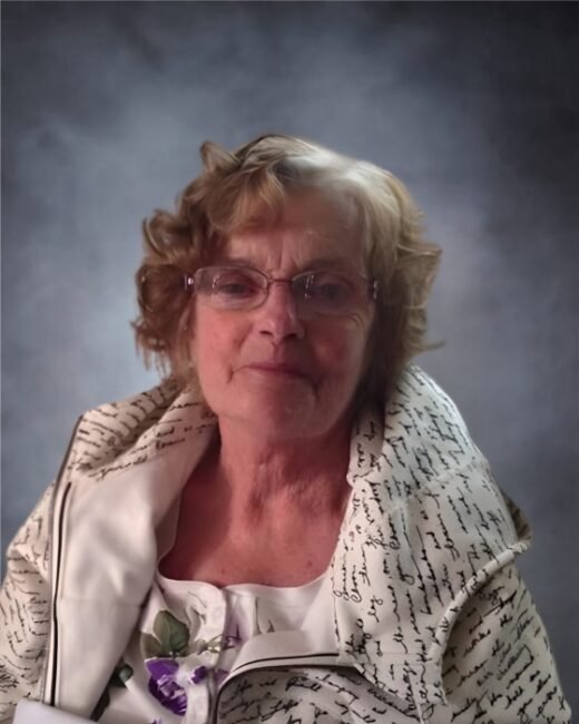 Elderly woman with glasses and patterned jacket