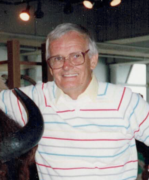 Smiling person with glasses and striped sweater