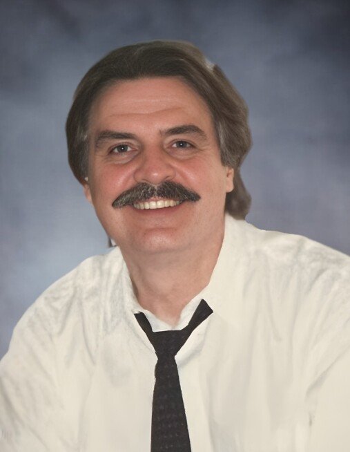 NEGRAZIS, Al Negrazis Smiling man with mustache in white shirt and tie.