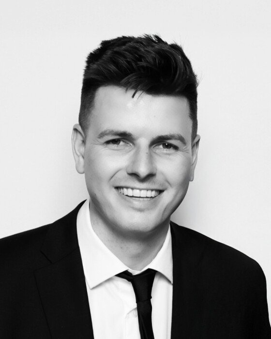 CHARTERS, Cameron Charters Smiling man in a suit portrait.