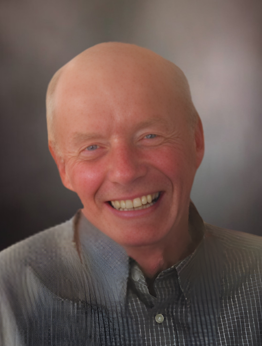 Smiling bald man in checkered shirt portrait.