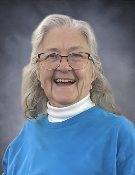 Smiling older woman with gray hair and glasses.