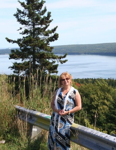 Woman near lake with scenic mountain view