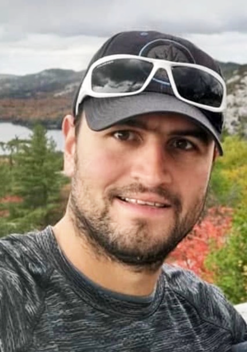 Person wearing sunglasses and cap outdoors