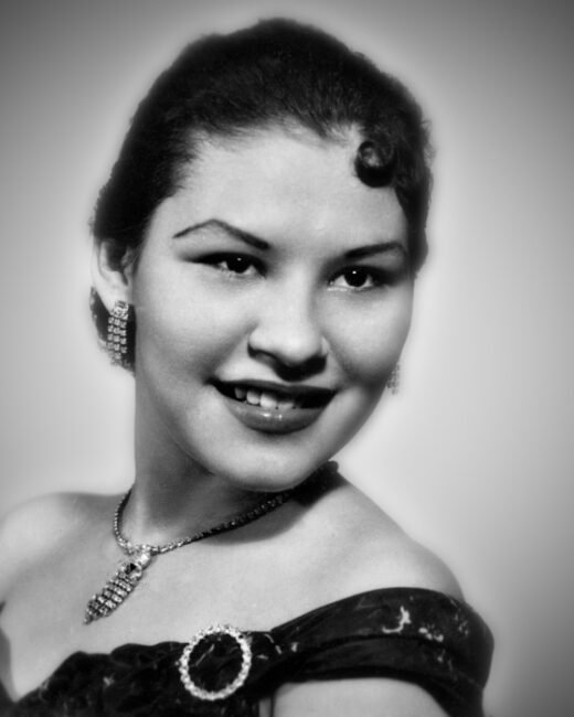 Vintage portrait of smiling woman with elegant jewelry.
