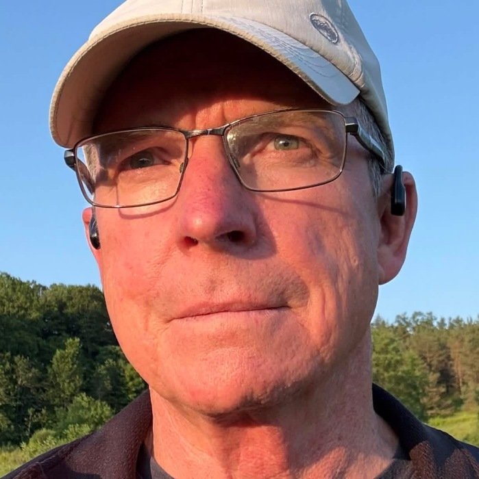 SNODDON, Stephen B. Snoddon Man outdoors wearing glasses and cap