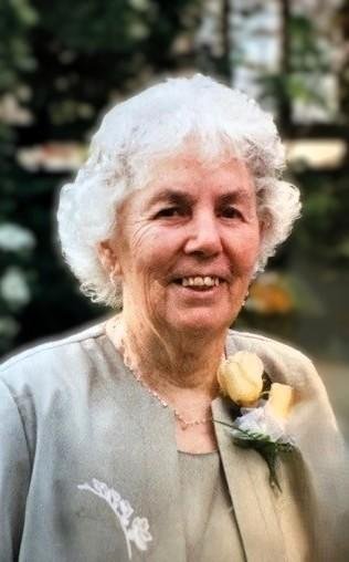 Smiling elderly woman with flowers, outdoors