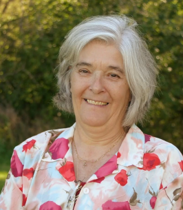 Smiling woman in floral shirt outdoors