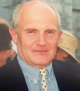 Smiling man in suit and striped shirt