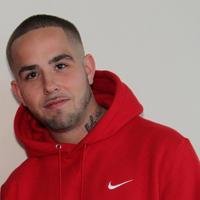 Person in red hoodie with short hair.