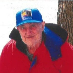 Elderly man wearing blue cap and red jacket