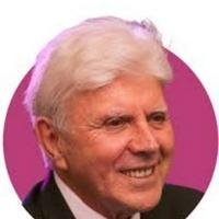 Smiling elderly man with white hair.