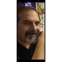 Smiling man with a beard indoors