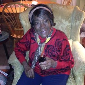 Smiling woman sitting in a cozy chair.