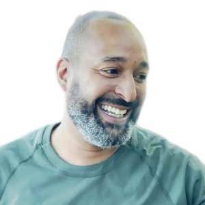Smiling man with beard and green shirt