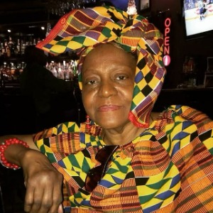 Person in colorful traditional attire at a bar.